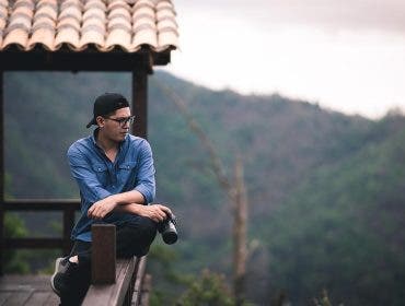 person on a mountain taking photos with a Canon EOS Camera