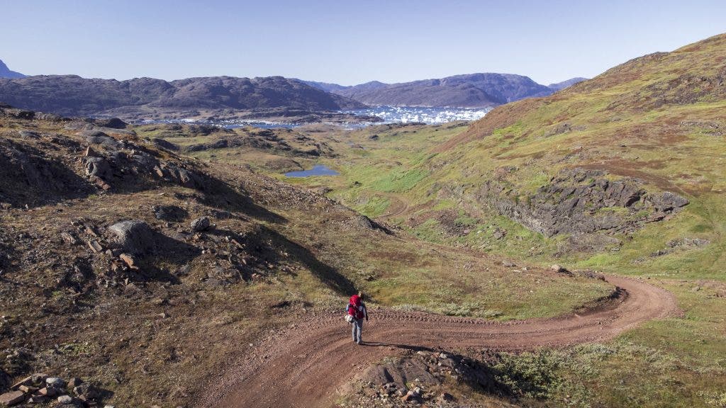 Drone photo of Stephanie solo backpacking Greenland for solo travel photography
