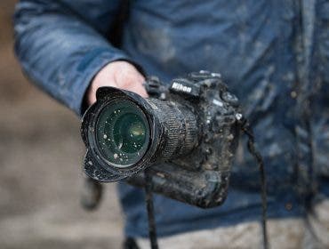 Nikon shooter in the field - Nikon covered with mud but still working
