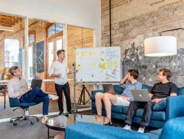 A photo of men strategizing how to market your drone services effectively