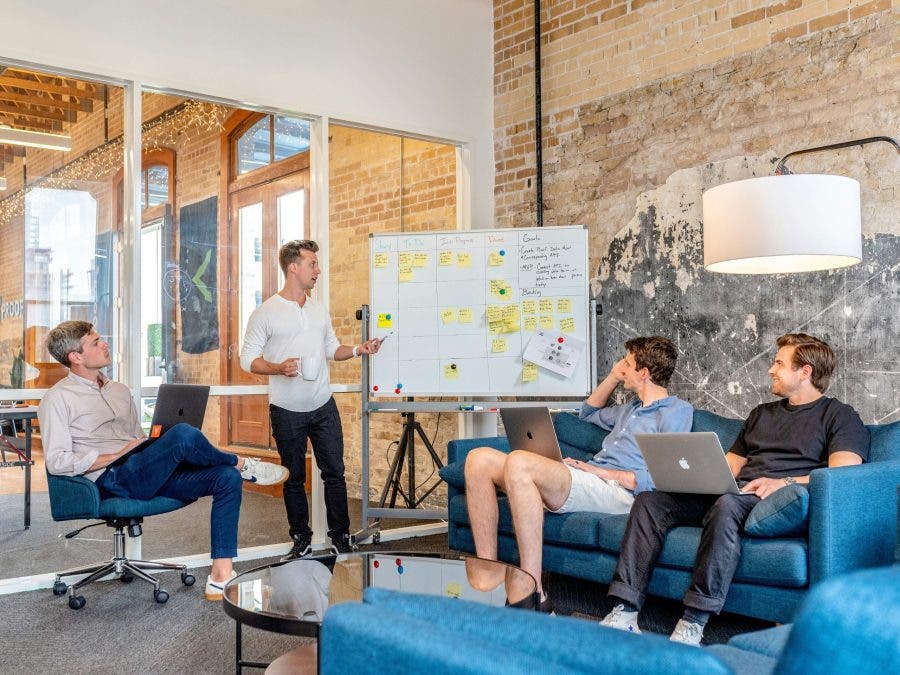 A photo of men strategizing how to market your drone services effectively