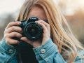 Female Canon EOS photographer looking through her camera