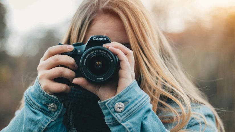 Female Canon EOS photographer looking through her camera