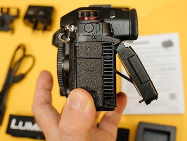 Paris, France - Nov 20, 2022: POV male hand holding new Panasonic Lumix DMC-GH6 Micro Four Thirds System digital still video camera with 5k 10 bit Video recording - fan tilt screen