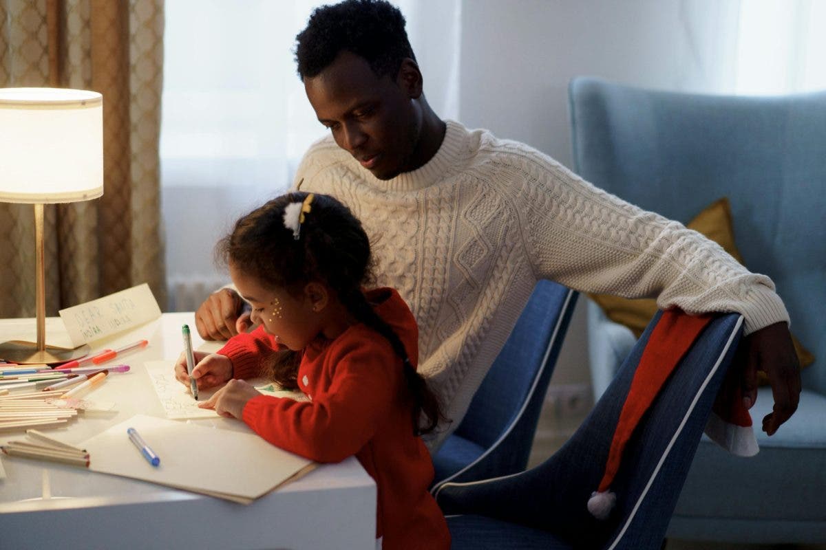 a photo of an older brother discussing the best gift ideas for siblings who love to draw
