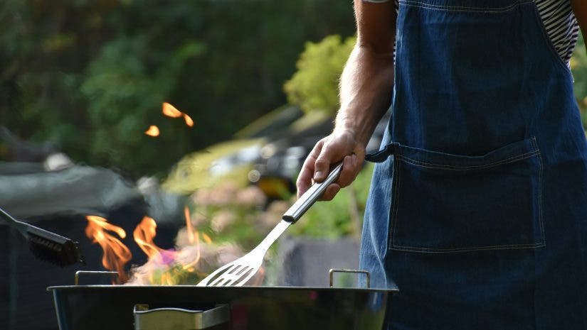 someone cooking in their backyard entertaining setup