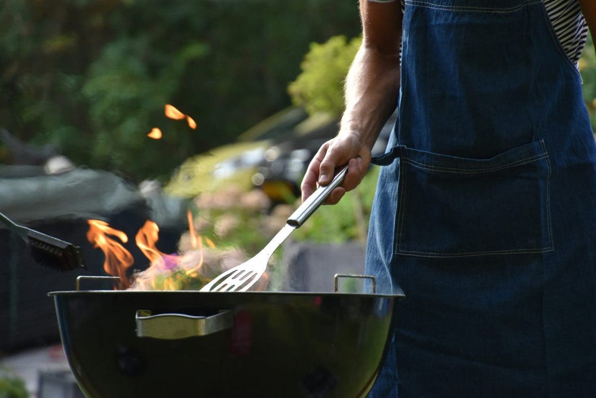someone cooking in their backyard entertaining setup
