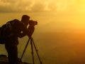 A male photographer travels and shoots landscapes at sunset Landscape photography gear
