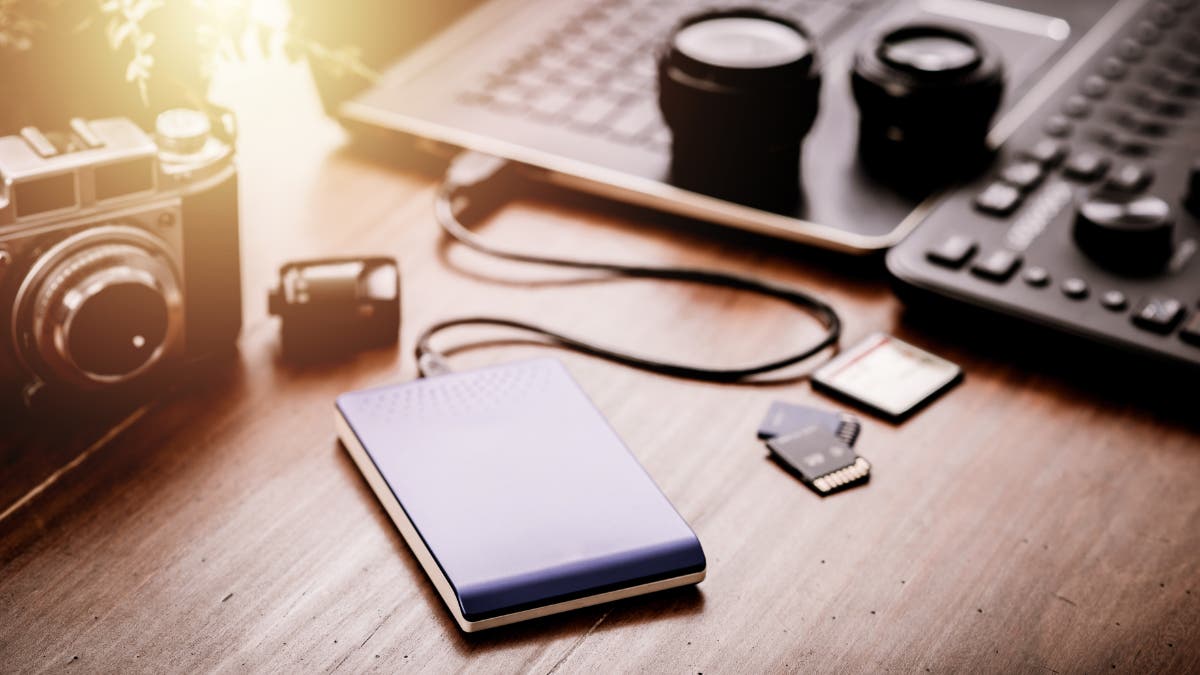 Closeup external hard drive on wooden desktop. Working with external hard drive. Solid State Drive