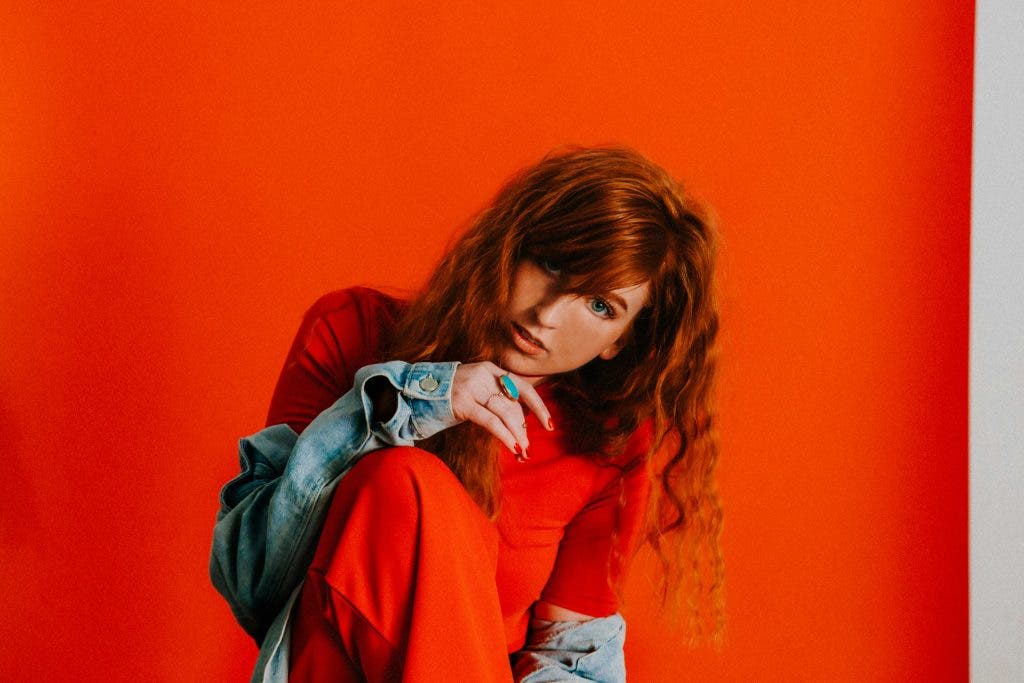 a fashion model in front of a red background