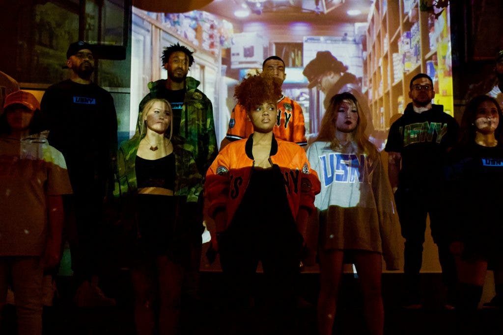 a group of models in front of a projector
