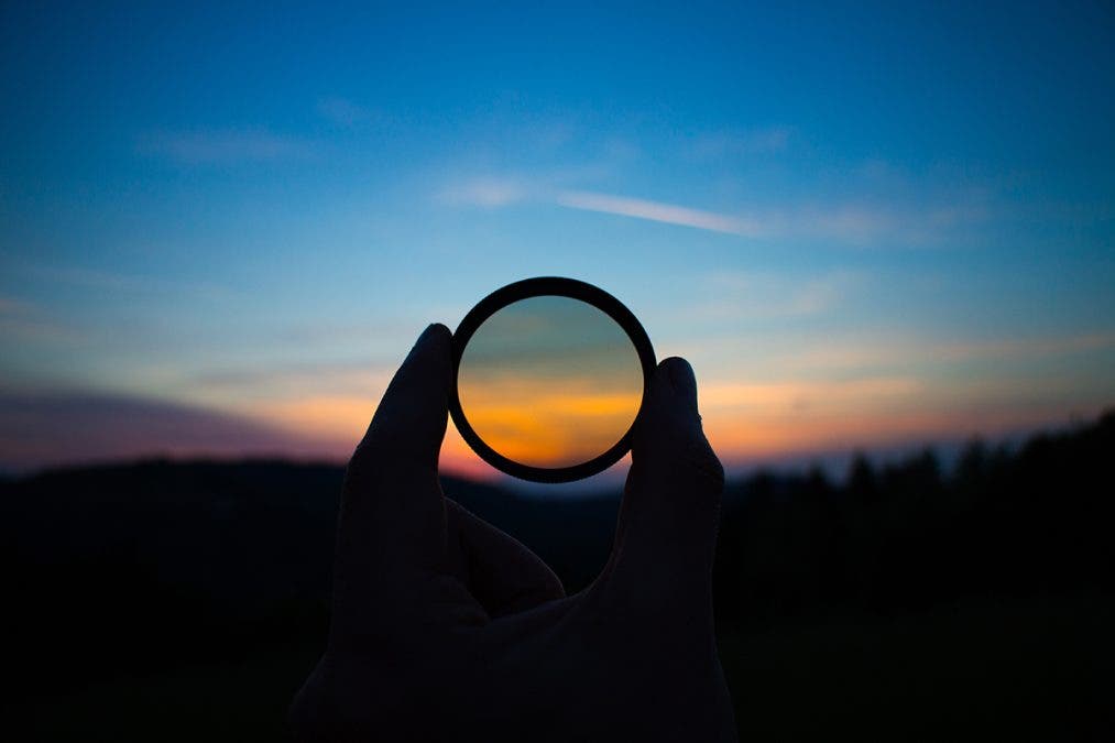 Hand holding filter lens camera, sunset, mountain, landscape