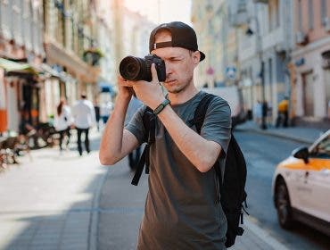 man-taking-photos-on-a-travel-with-his-camera