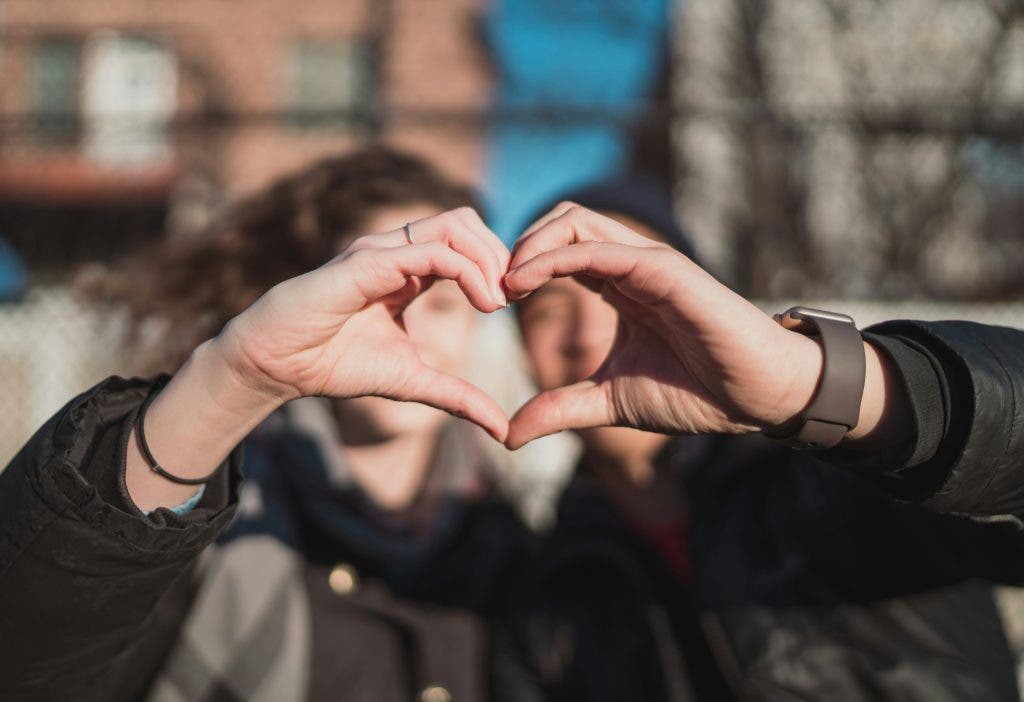 two people forming a heart sign on Valentine's Day
