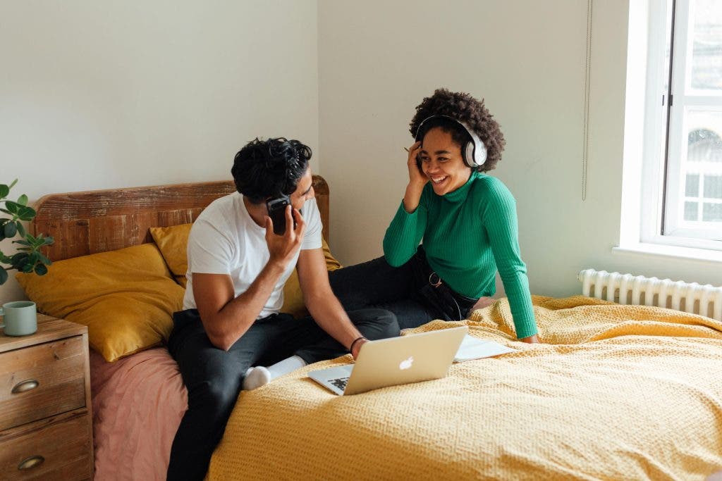 a couple in bed listening to music