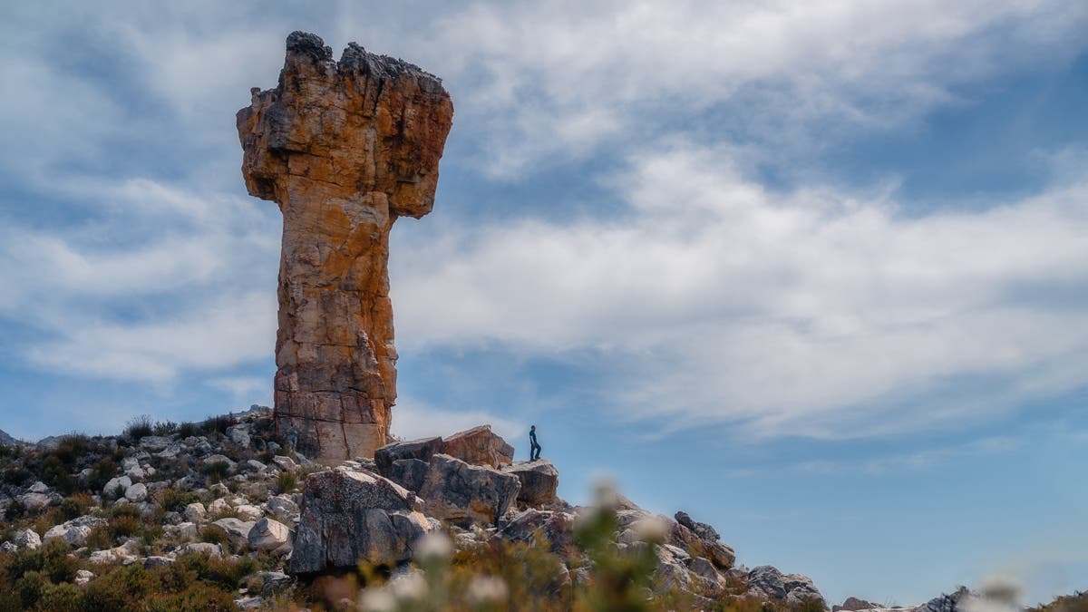 • Muji standing at Maltese Cross caption: Two hours of sweat and determination led me to this breathtaking sight! Just like this hike, life is all about gradual progress.