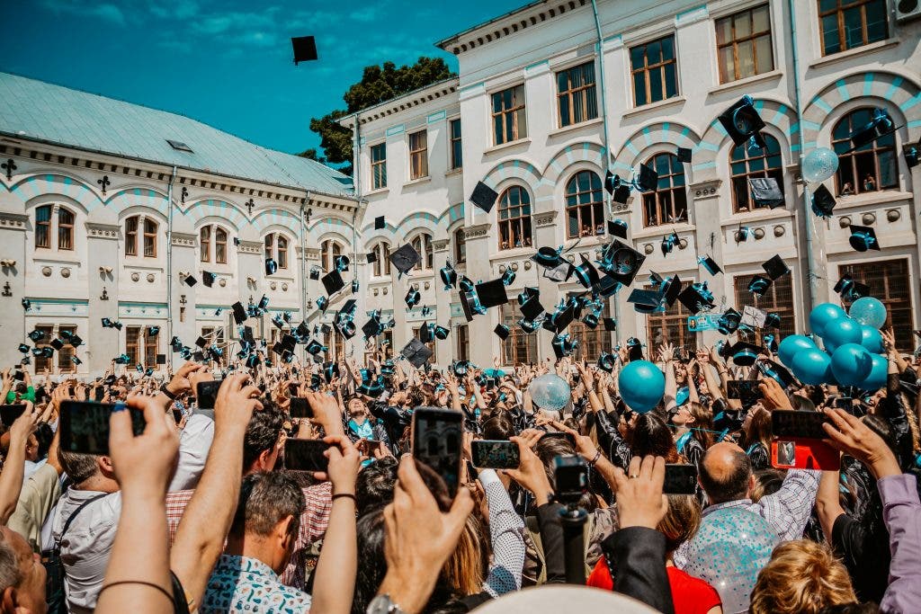 a cap toss with balloons floating