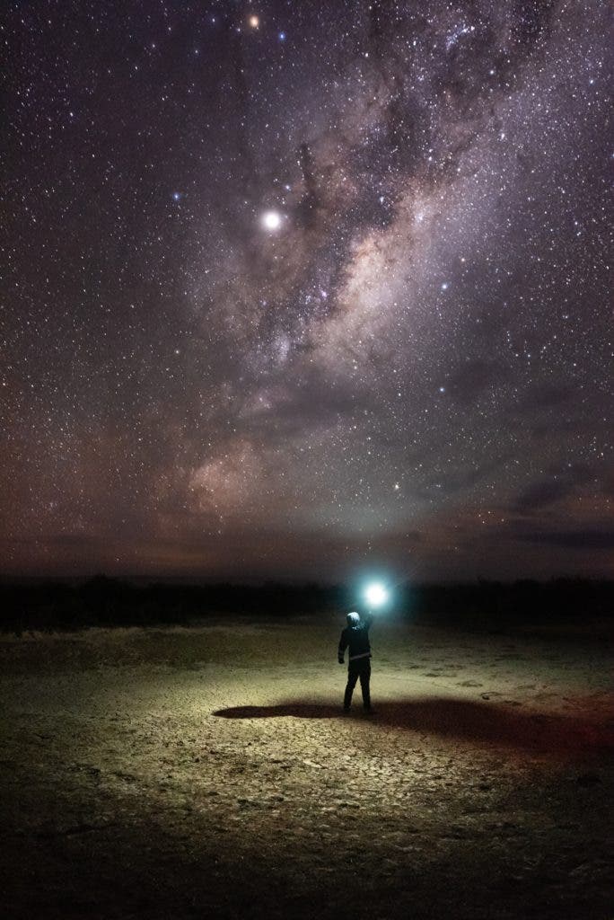 In the photo below, a long exposure was used to capture the night sky. While the person is the subject, the undeniable strong visual anchor is the Milky Way.