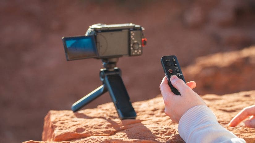Sony GP-VPT3 hand of female subject camera on tripod using remote.- Photo by Austin Jame Jackson