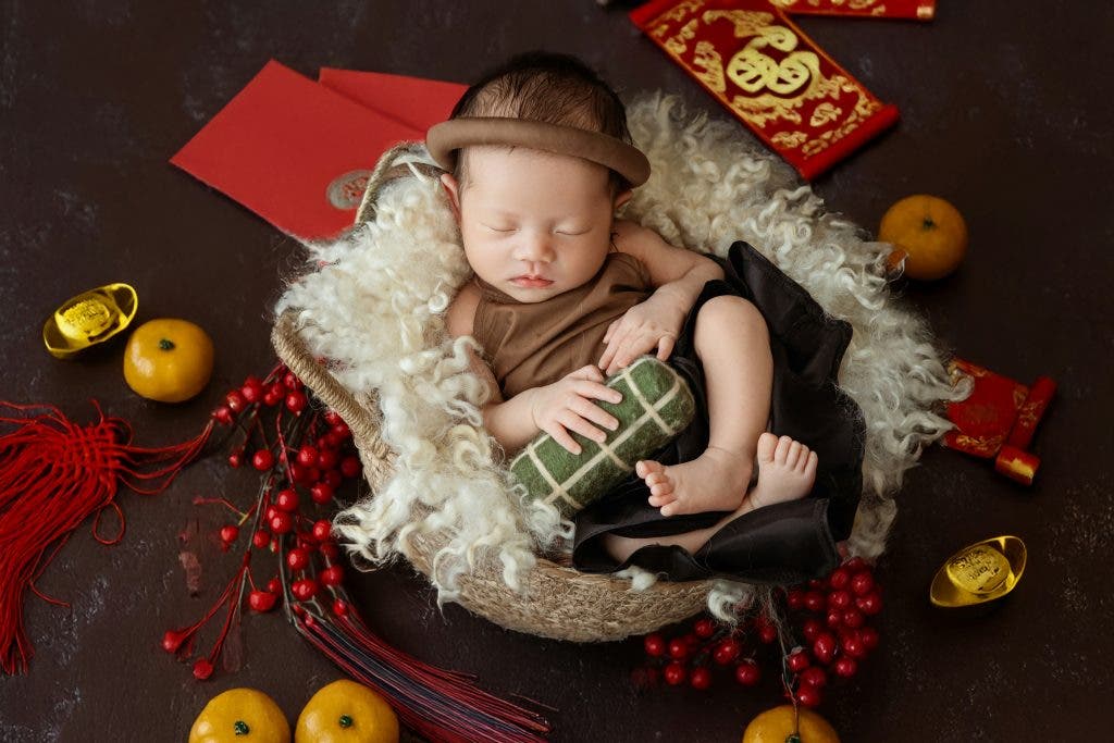 a baby is sleeping in a bowl with decorations surrounding it