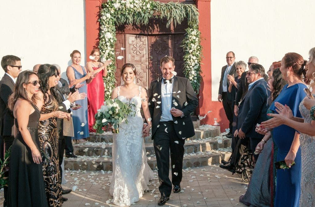 the wedding couple walking out of their wedding church