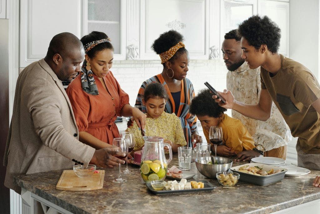 a black family gathered around a table