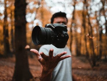 a photographer tossing a DSLR into the air