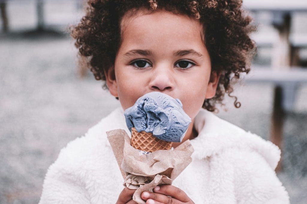 kid eating grey ice cream