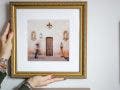 Woman hanging a framed printed photo