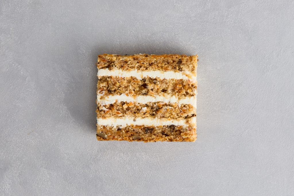 Slice of Carrot Cake on Minimalist Background Layered Texture and Subtle Elegance.