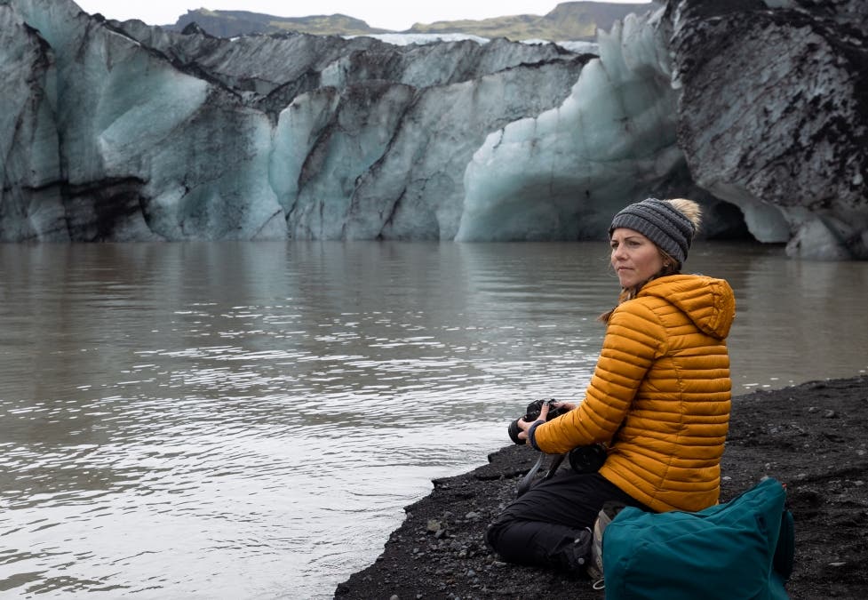 Stephanie, a travel journalist, holding her camera in Iceland