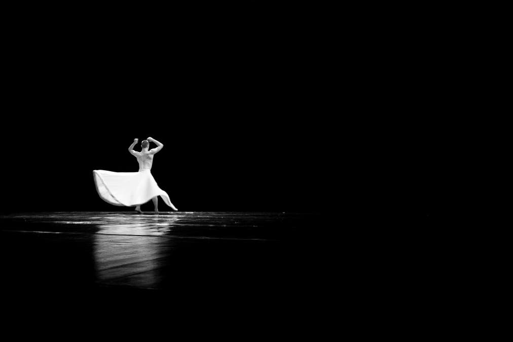black and white photography showing man dancing in white dress
