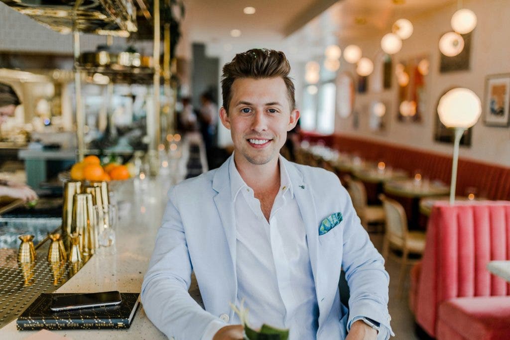 This shows a frame of a man at a bar with practical lighting, adding to the cinematic feel