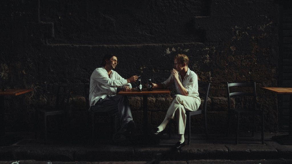 Dramatic light on two people seated at a table