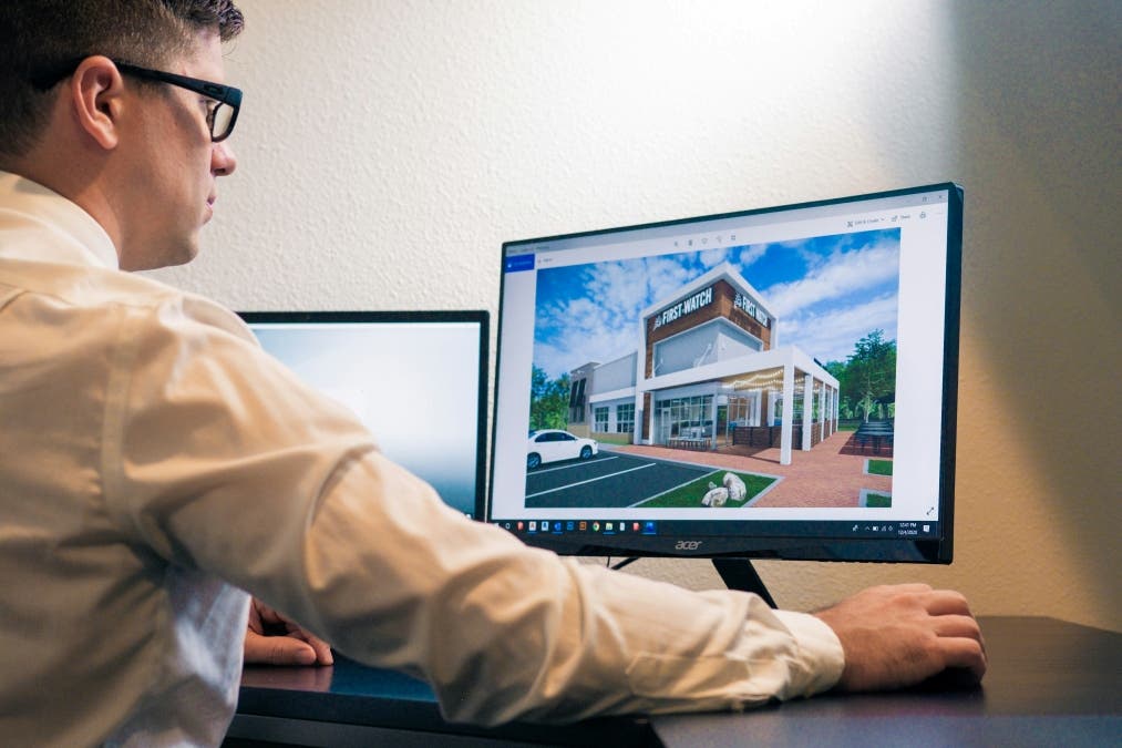 a student using a laptop and a monitor