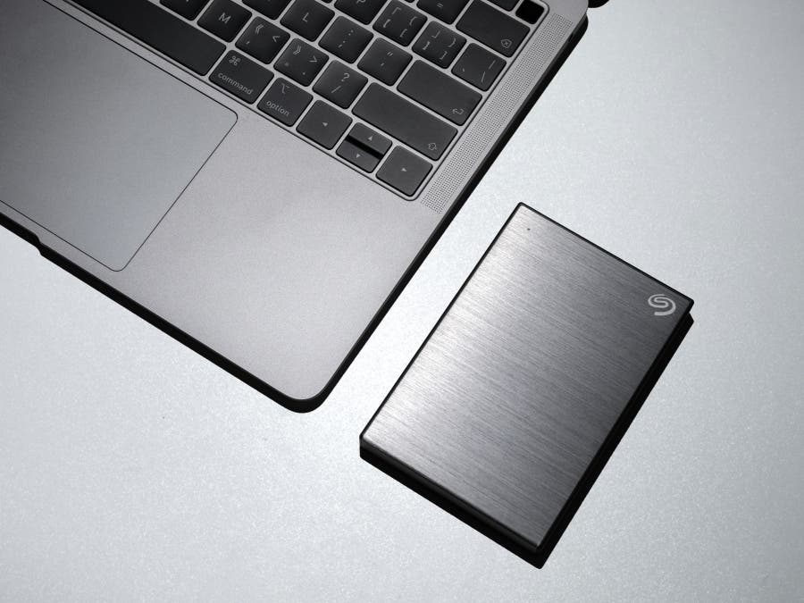 photo of a laptop beside a hard drive