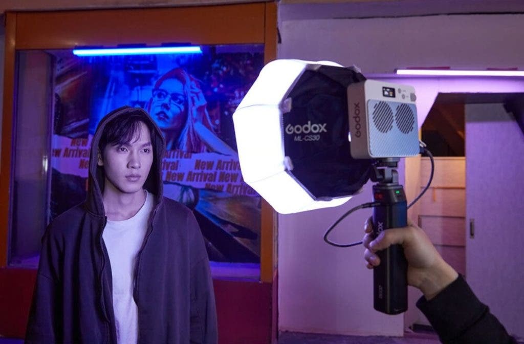 model looks into Godox light for a picture