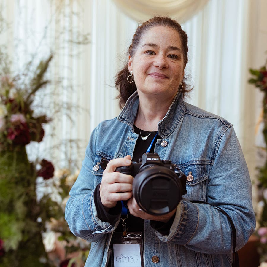 Jennifer Mullowney author portrait, holding her camera