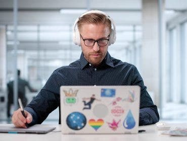 Male Graphic Designer Using Laptop To Edit Web Print Design