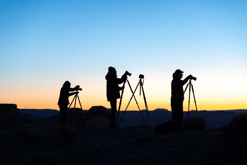 photographers lined up at a sunset for a photography workshop