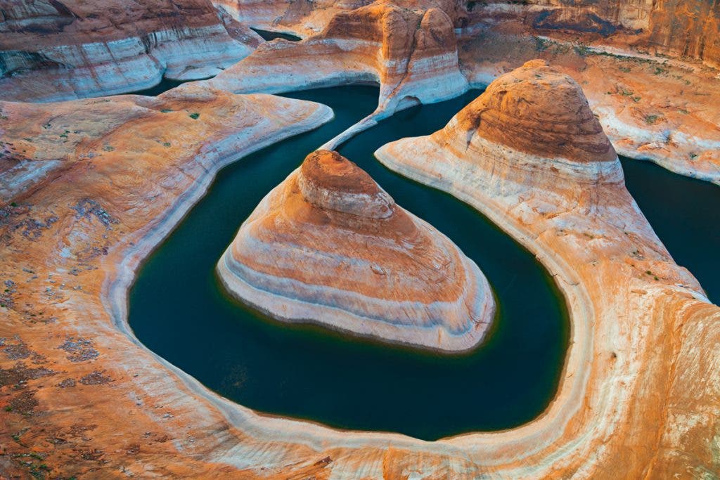 Lake Powell is one of the most interesting subjects to photograph in all of the Southwest. With the lake being over 180 miles long and thousands more miles of side canyons, there are virtually unlimited photo possibilities. This particular composition is accessed via a long dirt road and over 20 miles of hiking. I knew I wanted to capture the curvature of the lake, but the cliff edge I was standing on was sloped, so I couldn’t perfectly see the edge of the water. Drones are not allowed at Lake Powell, so I was forced to think outside the box. I put my camera on a tripod, used the 10-second timer, and held the tripod as far as I could overhead, aiming down at the lake. It took a few tries, but I was able to capture this image once I had it dialed in.