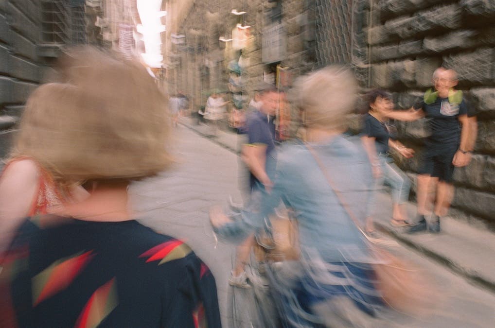 blurry photo of people walking in Florence