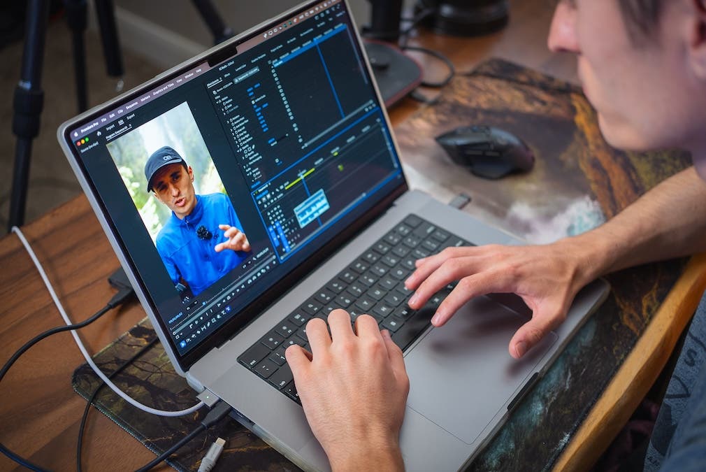 a man editing vertical videos on his laptop