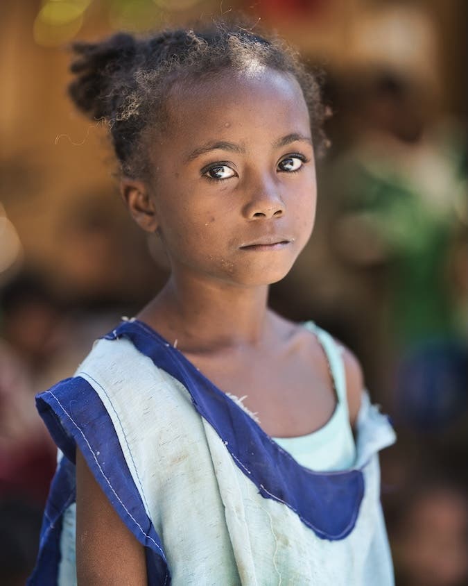 I couldn’t bring myself to edit her photo. Her eyes looked deep into my soul, and I sobbed. Her school had broken down; it had no stationery, electricity or other facilities. As I took her photo, her teacher ran to pull her torn uniform back on her shoulders quickly. Kamran is now using the funds to rebuild her school. We have also initiated another project to construct a school in another village.