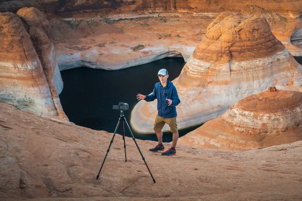 man poses in front of his camera