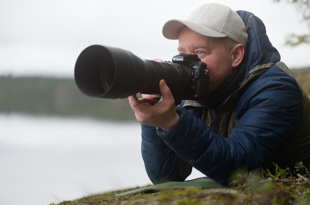 photographer posing with his equipment