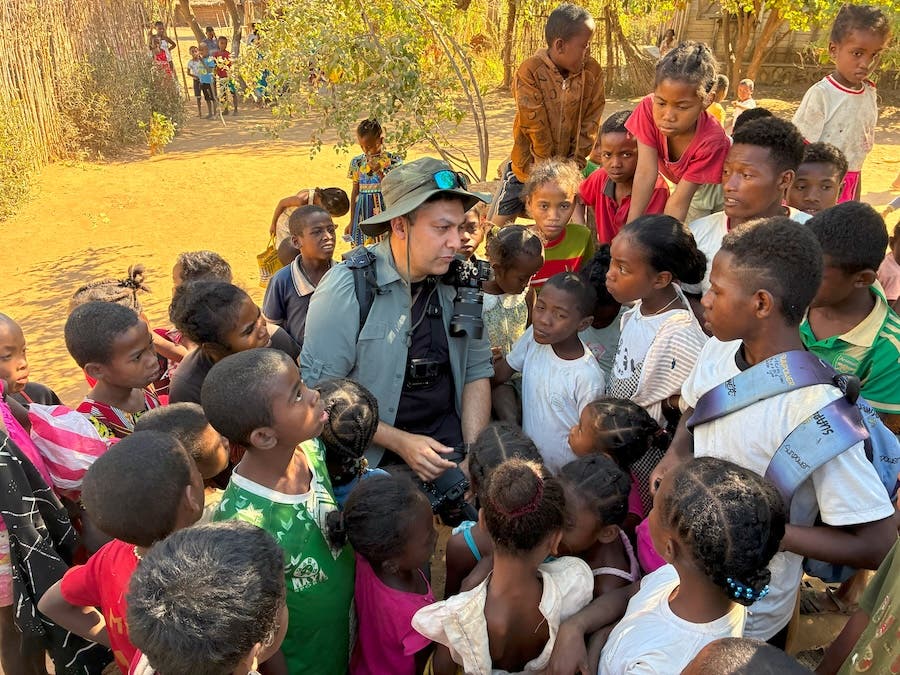 Surrounded by village kids who were fascinated by my gear, especially an Instax mini printer. Everyone wanted their photo after they realised that when paper comes out of this machine, and if you shake the paper and blow on it, your face appears on it. A magic trick I used to make friends!