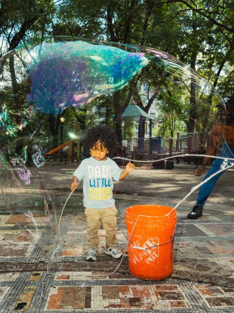 child playing with bubbles