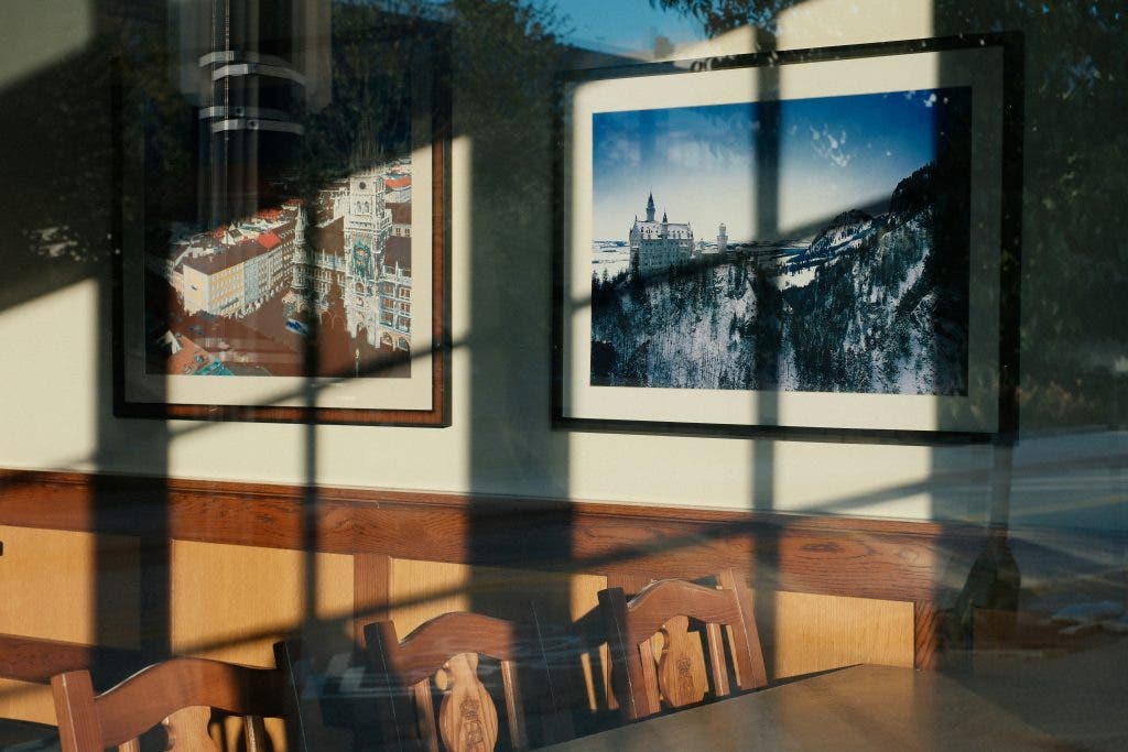 photos on the wall with a shadow of a window