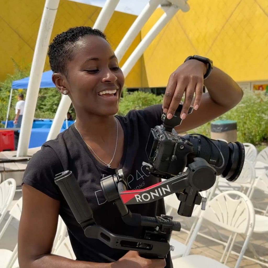 A videographer holds a Sony FX3 mounted on a DJI Ronin gimbal, providing a stabilized, mobile secondary angle for this two-camera setup.